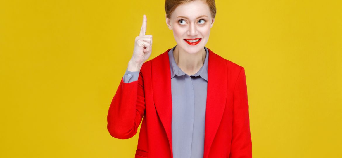 Ginger red head business woman in red suit have good plan, idea.